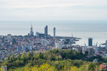 Fototapeta premium Panoramic urban skyline with coastal horizon seen from hilltop point.