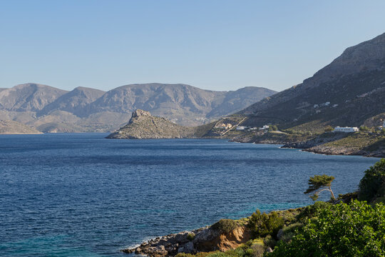 Lush and mountainous landscape and the Aegean Sea seen from Masouri (Massouri) towards north on Kalymnos island in Greece on a sunny day.