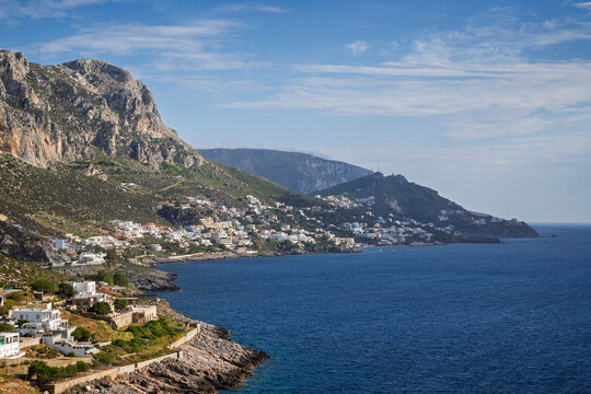 Mountainous and rugged landscape, coastline and the Aegean Sea towards the village of Masouri (Massouri) on Kalymnos island in Greece on a sunny afternoon.