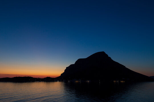 Scenic view of silhouette of steep and mountainous Telendos island in Greece during blue hour at dusk. Copy space.