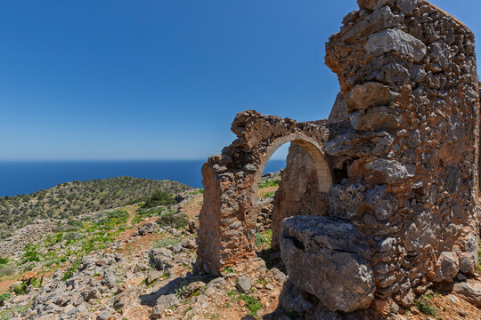 Old ruins along the Katholiko (or Avlaki) Gorge hiking train in Crete, Greece, on a sunny day.