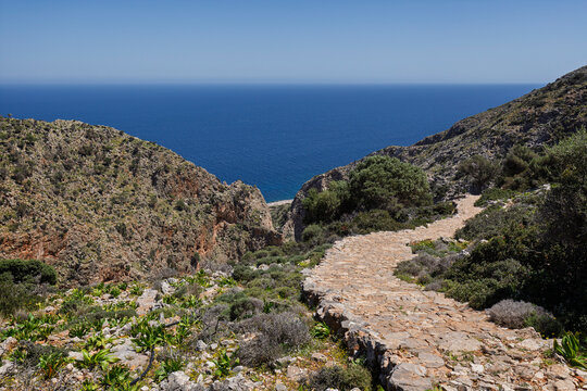 Lush and hilly landscapes along the Katholiko (or Avlaki) Gorge trail in Crete, Greece, on sunny day.