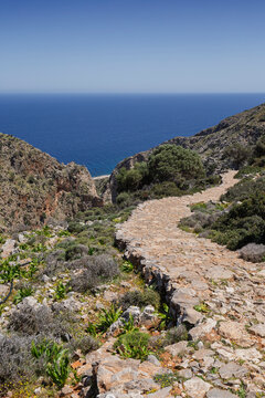 Lush and hilly landscapes along the Katholiko (or Avlaki) Gorge trail in Crete, Greece, on sunny day.
