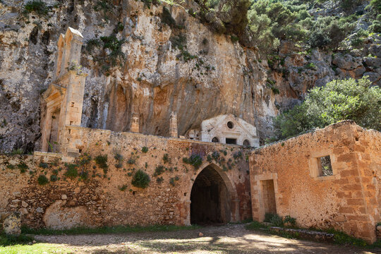 Old and empty ruins of the Katholiko monastery located on the cliffside along the Avlaki Gorge hiking train in Crete, Greece.