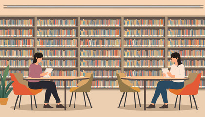 Two women reading books at separate tables in a quiet library with extensive bookshelves filled with various titles. © Roma