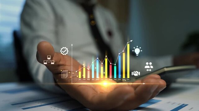 Business man holding a glowing hologram digital bar chart and icons above an open hand, Business data growth analytics and modern business strategy in an office 