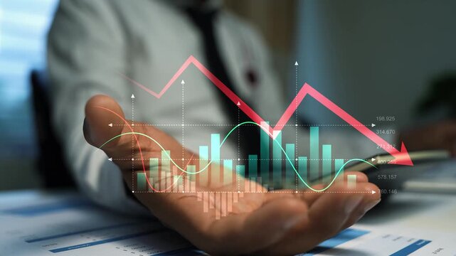 Businessman holding a hologram financial graph chart with falling arrow and data bars, Business market decline risk loss and economic analysis in an office 