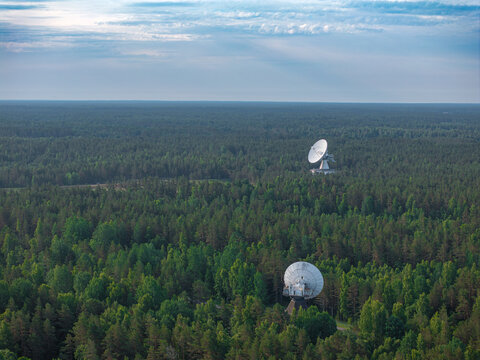 Aerial view of Irbene radio telescopes RT-32 and RT-16 surrounded by forest in Latvia