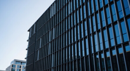 Fototapeta premium Modern Glass Facade Office Building Under Clear Sky