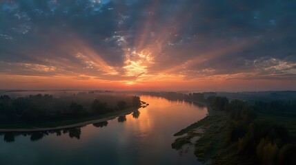 Fototapeta premium Sunrise reflecting on distant river bend symbolizing hope guidance and continuity