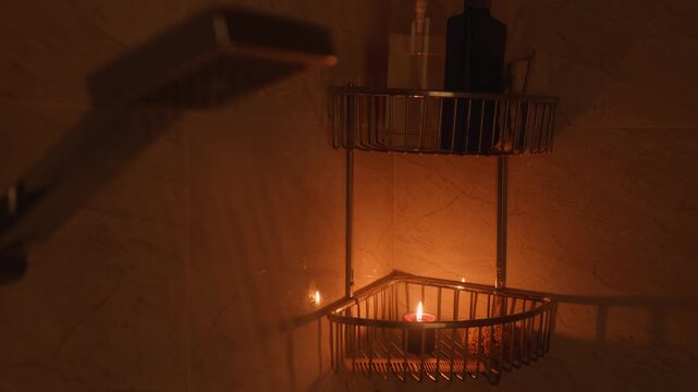 Showering in the dark candle burning softly on a metal shower caddy, creating a tranquil atmosphere for relaxation and well being