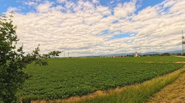 4K Timelapse video with moving clouds and a church near Loh, Stephansposching, Deggendorf, Bavaria, Germany
