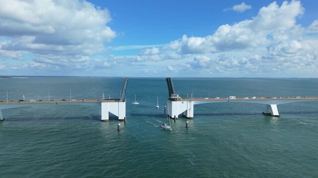 Zeelandbrug bascule bridge opening for sailboats and boats on the Oosterschelde estuary in the Netherlands on a sunny day