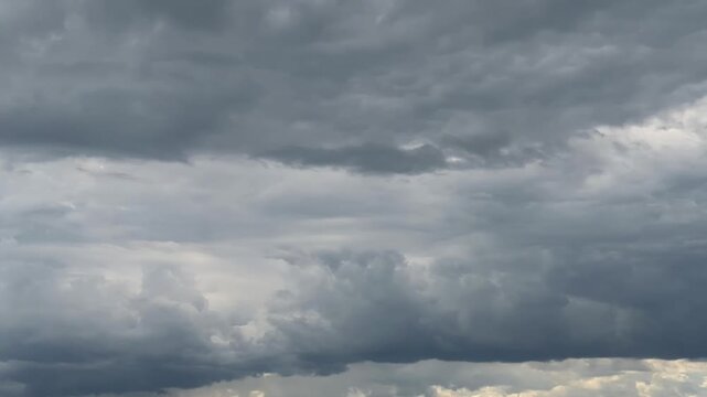 Timelapse 4k storm dramatic clouds are floating across the sky. Stormy sky with dark, snowy clouds on a spring day. Clouds are floating across the sky. Dark blue clouds swiftly floating across sky. 