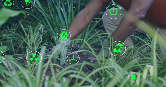Man kneeling tending soil, gloved hand initiating floating recycle and CO2 icons for sustainability