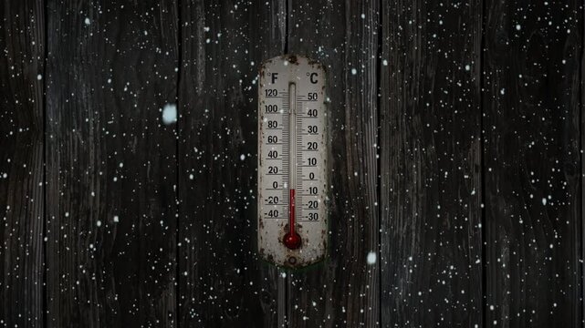 Weathered outdoor thermometer in winter