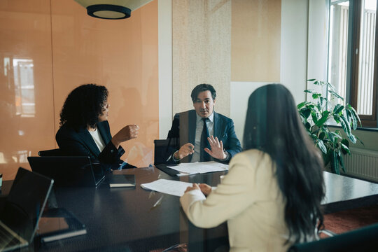 Male business expert negotiating agreement deal with corporate partners at office meeting room