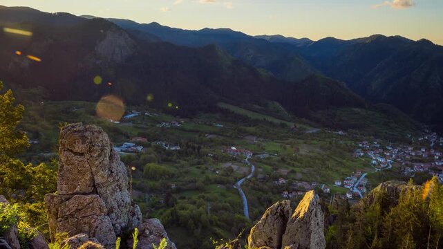 View from rock to town of Smolyan with meadows for cattle walking and houses between mountain range of Rhodope Mountains