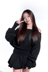 Playful Young Asian Woman Showing Peace Sign and Sticking Tongue Out © Saddha Visual