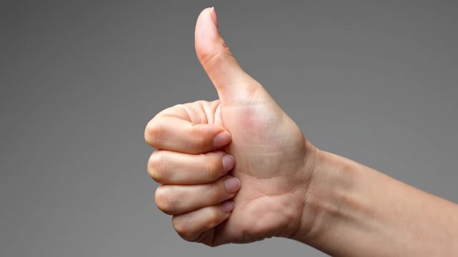 Close-up of the hand with a thumbs-up gesture and a thumbs-up like gesture