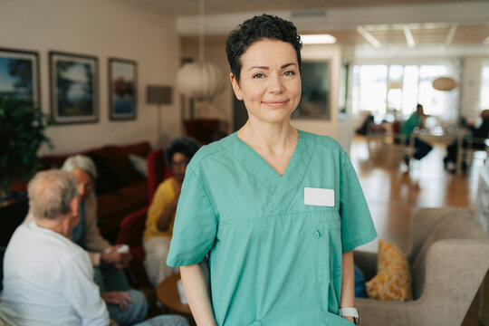 Portrait of confident female nurse at elder care facility