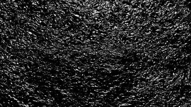 abstract textured background of crumpled silver metallic foil gleaming under stark dramatic studio lighting