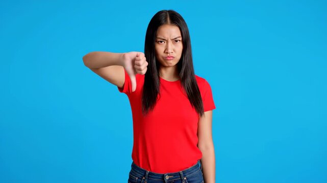 Woman in red makes gesture in front of blue background, woman likes gesture in conjunction