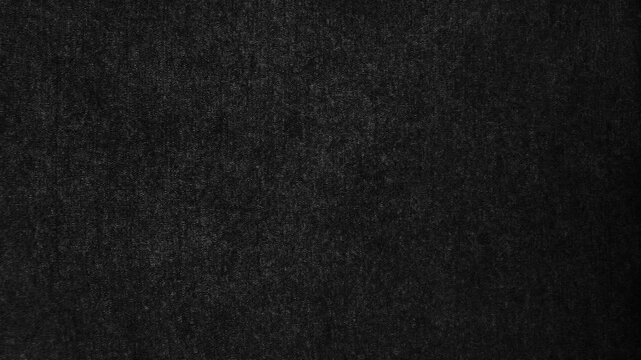 dark black canvas fabric texture ripples gently revealing subtle woven details in a cinematic moody backdrop