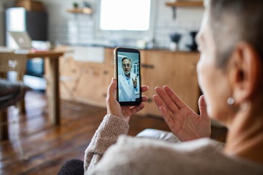 Woman having telehealth video call with doctor at home