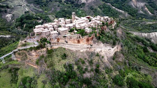 Cinematic aerial drone footage of the stunning, isolated medieval hilltop village of Civita di Bagnoregio, known as "The Dying City", Lazio, Italy &ndash; 2023