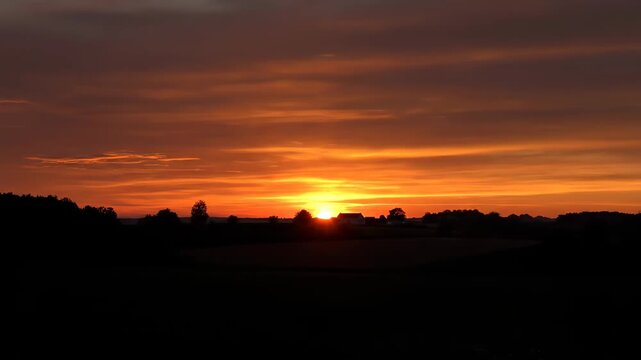 Field scenery at sunset, beautiful sunset sky delayed