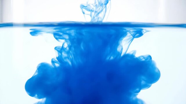 The moment a blue object enters the water, the blue ink drips into the water and spreads