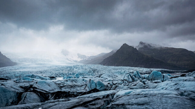 Moody glacier and dark peaks under heavy overcast Icelandic sky