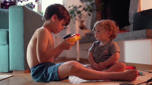 Older brother refusing to share toy with toddler sibling, highlighting sibling rivalry, child development and everyday family life