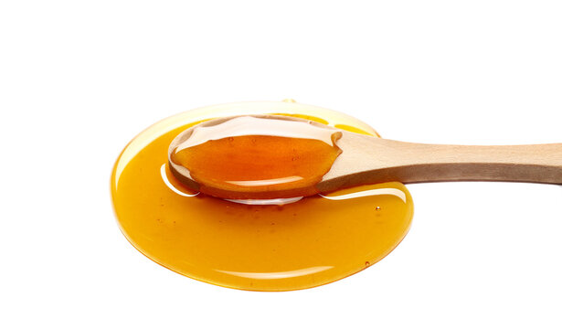 Natural honey puddle with wooden spoon isolated on white, side view