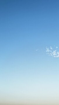 Minimal blue sky time lapse with small white cloud and clean copy space