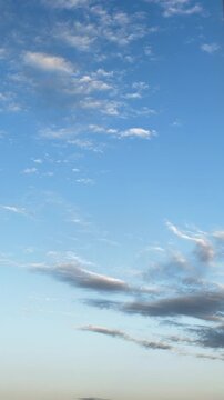 Atmospheric evening sky time lapse with dark cloud moving across blue horizon