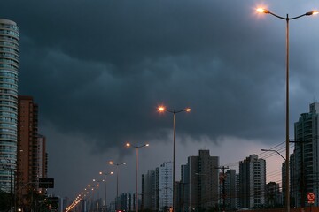 Obraz premium Stormy Sky Over Urban Landscape, Streetlights Illuminated