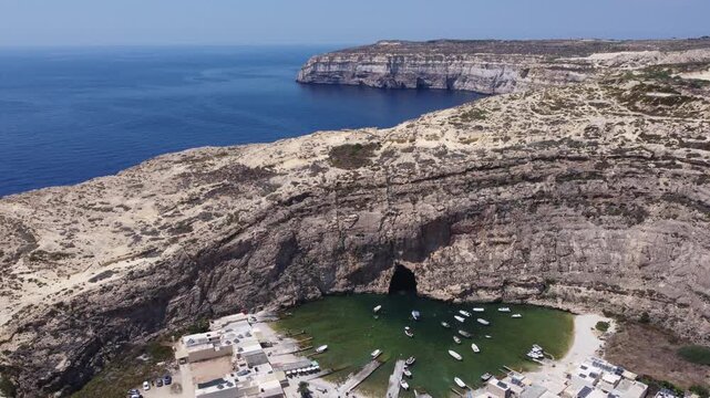 Dwejra Inland sea and cliffs on a sunny summer day. Aerial view Gozo island, Malta. High quality 4k footage