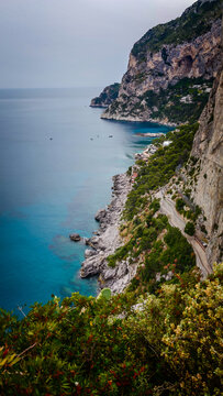 Rocky coastline of Capri Island with crystal-clear turquoise water, breathtaking Mediterranean seascape, dramatic cliffs and pristine coastal landscape in Italy