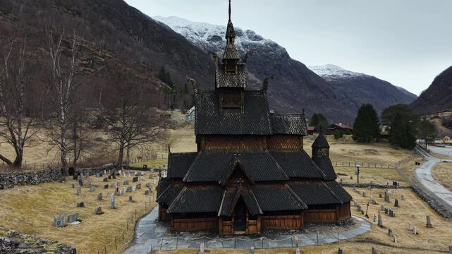 Medieval Borgund Stave Church in overcast weather, scenic drone panorama, Norway