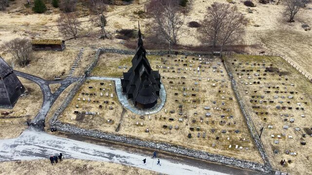 Medieval Borgund Stave Church in overcast weather, scenic drone panorama, Norway