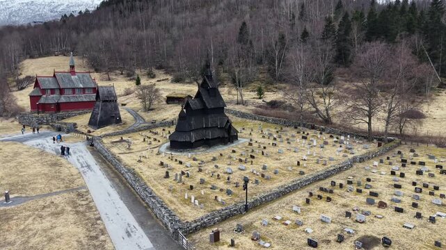 Medieval Borgund Stave Church in overcast weather, scenic drone panorama, Norway