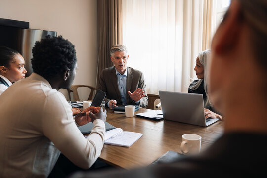 Senior male manager guiding his team during office meeting