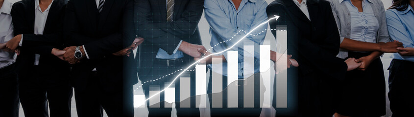 A corporate team stands confidently in front of a growth chart, representing financial success and teamwork in a dynamic business environment focused on progress. Axiom © InfiniteFlow