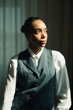 Serious female corporate worker looking away thoughtfully
