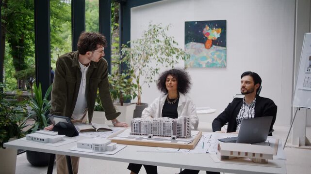 Architects gather around realistic model of residential complex