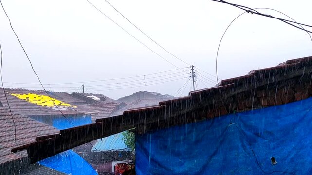 heavy rainfall on a roof of houses in the dadar village in maharashtra in india.