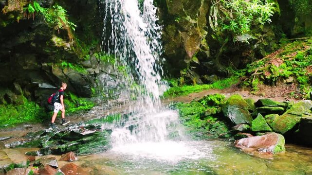 Young Boy Hiking Behind Grotto Falls In The Roaring  Fork Nature Area, Great Smoky National Park, Tennessee, USA