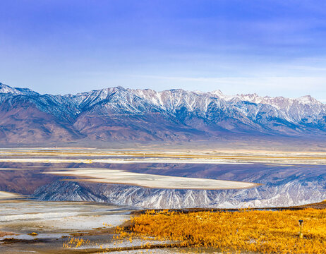 The Snow Capped  Sierra Nevada Mountains Reflection on The Flooded Salt Flats of Owens Lake, Lone Pine, California, USA